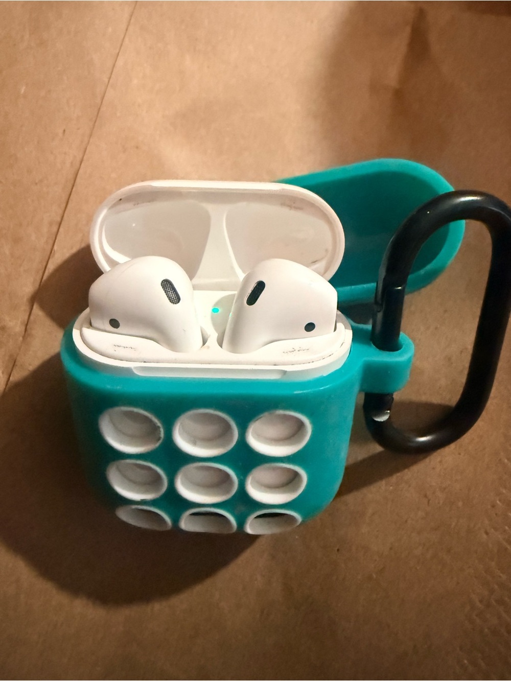 White Apple AirPods in Teal Silicone Case
